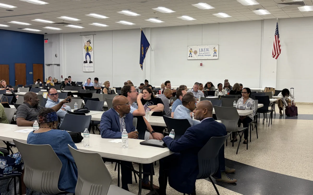 Members of the Fulton County Democrats talking together at tables during a county committee meeting in a union hall.