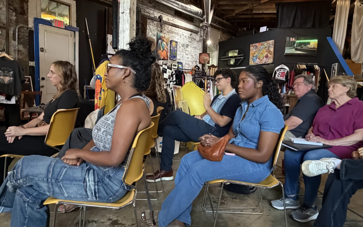 Mid Fulton Democrats seated together in conversation at a chapter gathering, one speaking while the others listen.