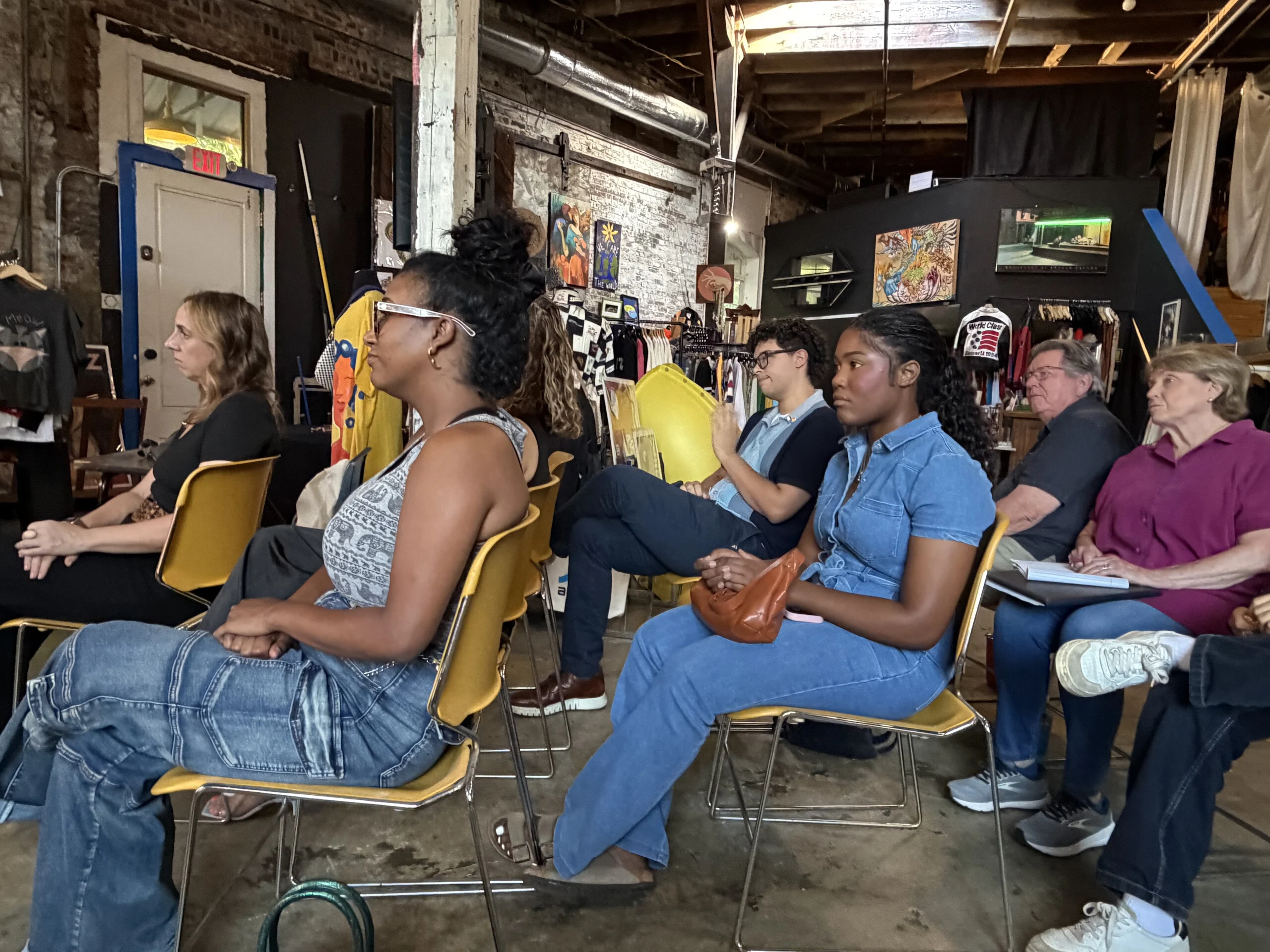 Mid Fulton Democrats seated together in conversation at a chapter gathering, one speaking while the others listen.